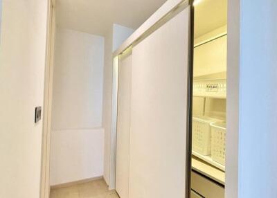 Storage room with sliding doors and organized shelves.