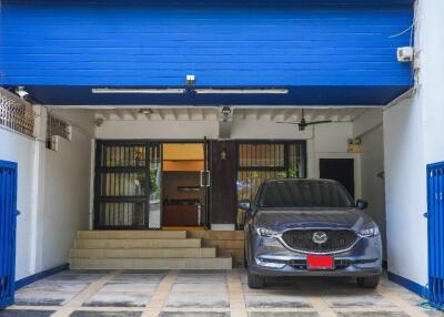 Covered garage with a modern SUV parked