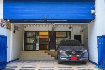 Covered garage with a modern SUV parked