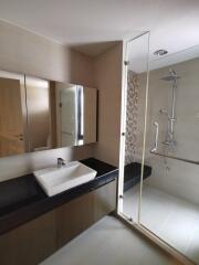 Modern bathroom with glass shower enclosure and vanity