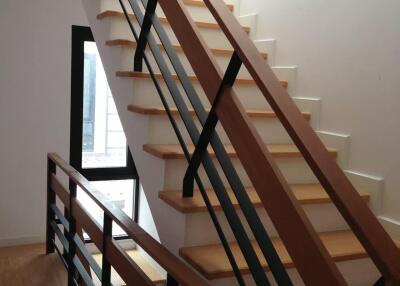 Modern staircase with wooden steps and metal railings