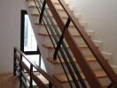 Modern staircase with wooden steps and metal railings