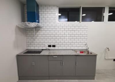 Modern kitchen with tiled backsplash and sleek cabinetry