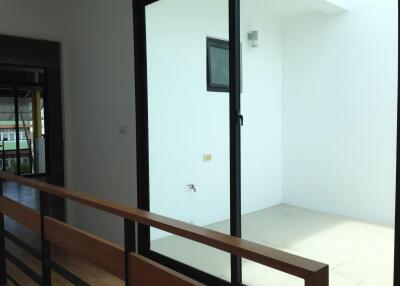 Minimalistic balcony area with glass door