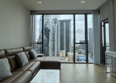 Living room with large windows and city skyline view