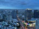 Aerial view of the city with skyscrapers and roads at dusk