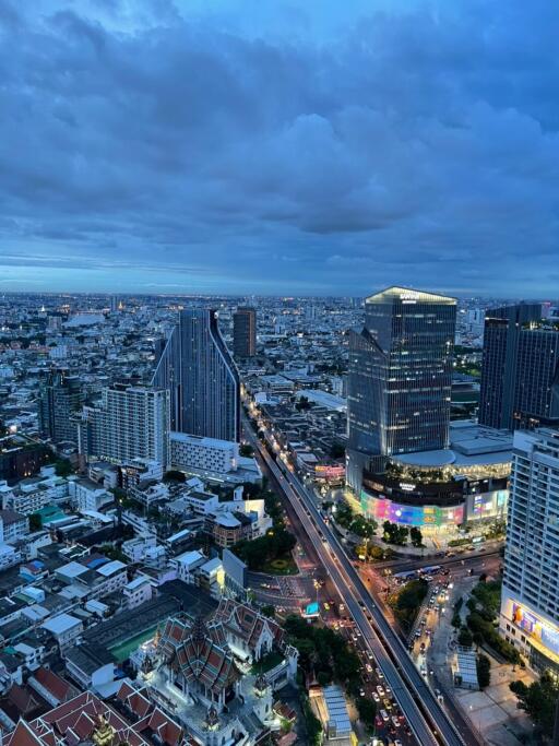 Aerial view of the city with skyscrapers and roads at dusk