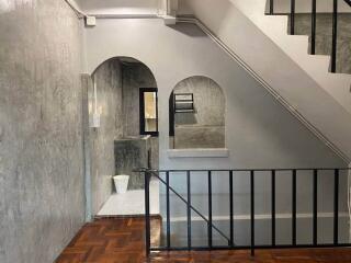 Staircase area with concrete walls and archways