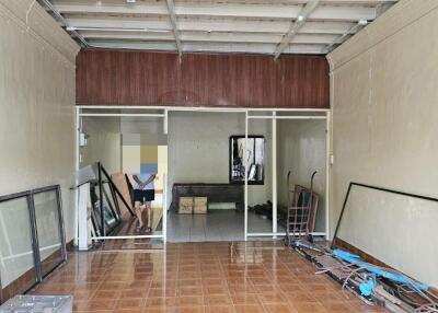 Empty space with tile floor and exposed ceiling beams