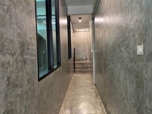 Concrete hallway with window and stairs