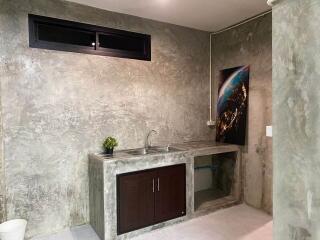 minimalist kitchen with concrete walls and modern artwork