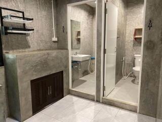 Bathroom with concrete walls and modern fixtures