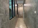 Modern concrete-walled hallway with stairs