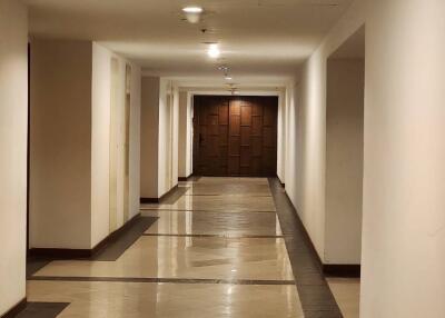 Building hallway with tiled flooring and recessed lighting