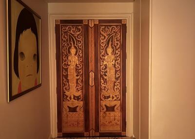 Elegant hallway with ornate double doors and patterned tile floor