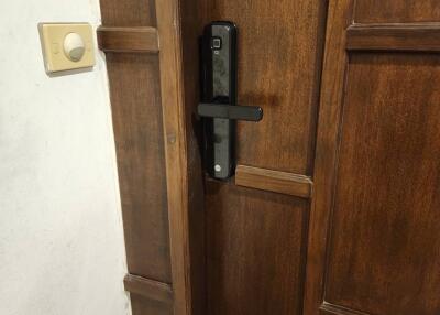 Close-up of a wooden door with a digital lock