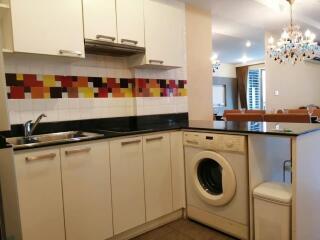 Modern kitchen with colorful backsplash and integrated appliances