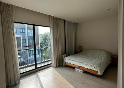 Bright bedroom with large windows and balcony
