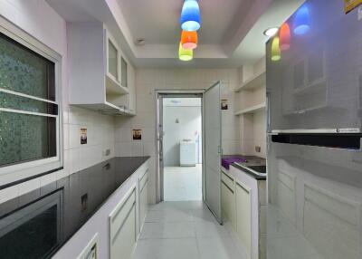 Modern kitchen with appliances and colorful lighting