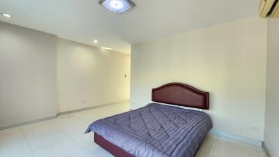 Spacious bedroom with modern lighting and air conditioning