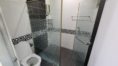 Modern bathroom with glass-enclosed shower and toilet