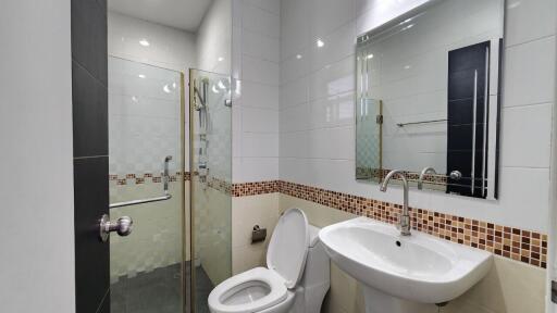 Modern bathroom with glass shower and white toilet