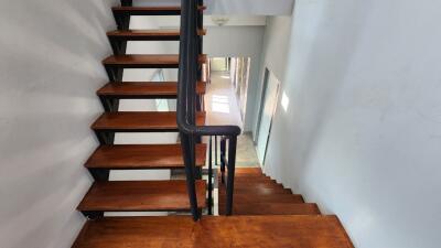 Indoor staircase with wooden steps and black railings