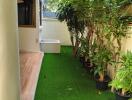 Outdoor garden with potted plants and artificial grass