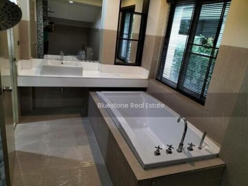 Modern bathroom with large mirror and bathtub