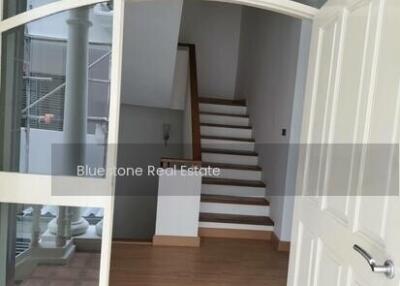 View through a front door showing staircase leading to the upper floor