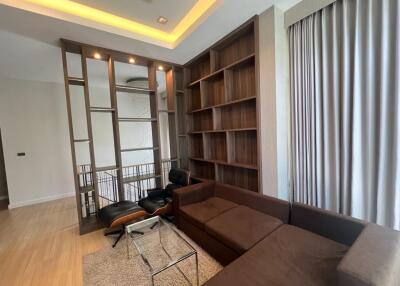 Modern living room with sectional sofa and built-in shelving