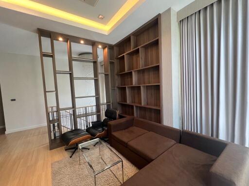 Modern living room with sectional sofa and built-in shelving