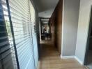 Modern hallway with wooden floor and blinds