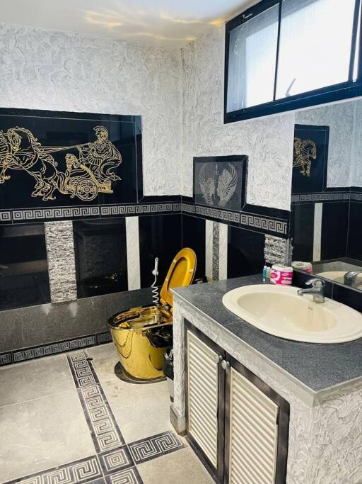 Decorative bathroom with gold accents