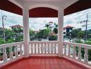 Balcony with view of other residential properties and greenery