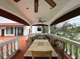 Covered outdoor patio area with seating and ceiling fans