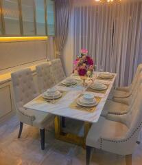 Elegant dining room with marble table and plush chairs