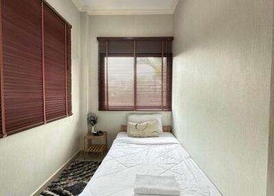 Cozy single bedroom with window blinds