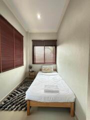 Cozy single bedroom with window blinds