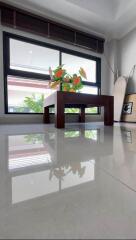 Modern living room with a wooden coffee table and a large window