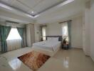 Spacious bedroom with a large bed, modern decor, and ample natural light