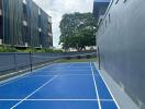 Outdoor sports court with blue flooring and net