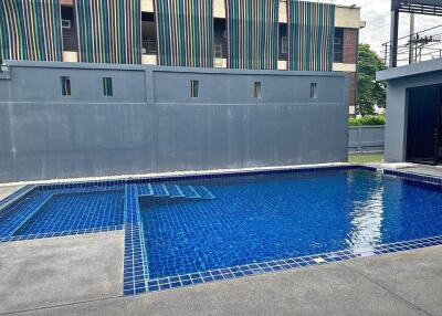 Outdoor swimming pool in a modern building complex