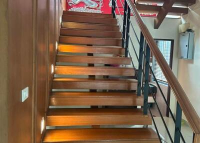 Wooden staircase with decorative red dragon wall