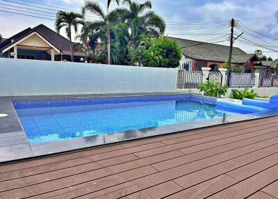 Swimming pool in a backyard with deck