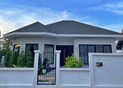 Front view of a single-story house with a gated fence