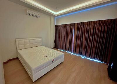 Spacious and modern bedroom with a large bed and elegant lighting