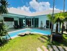 Outdoor view of a residential property with a swimming pool and garden