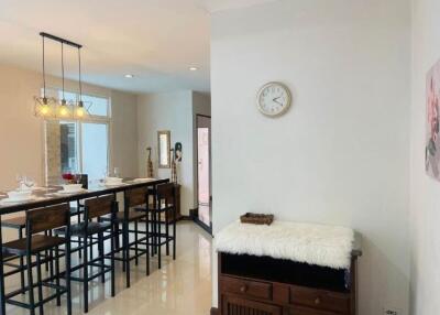 Dining area with table, chairs, and decorative lighting