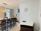 Dining area with table, chairs, and decorative lighting